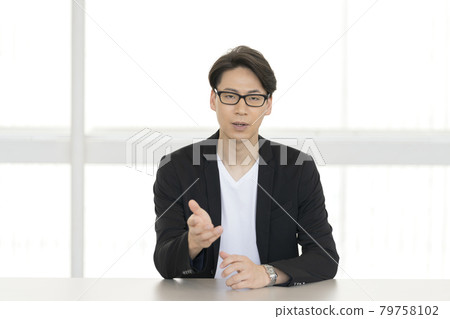 Portrait of a smiling man in his thirties talking looking at the camera Portrait of a smiling man in his thirties talking looking at the camera 79758102