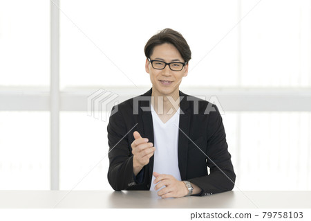 A smiling man in his thirties talking looking at the camera A smiling man in his thirties talking looking at the camera 79758103