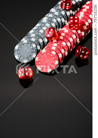 Red casino dice and chips isolated over black reflective background Red casino dice and chips isolated over black reflective background 79758286