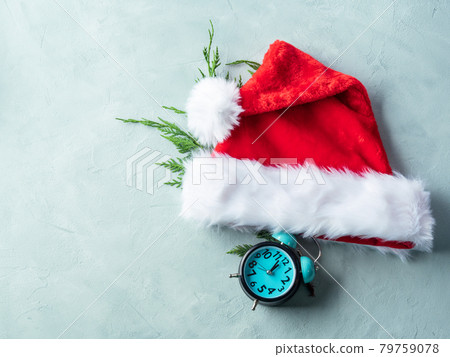 Santa Claus cap with fir tree branches and retro clock on turquoise gray background 79759078
