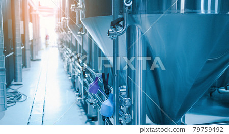 Modern interior craft beer production private microbrewery. Row of shiny metal micro brewery tanks. Modern interior craft beer production private microbrewery. Row of shiny metal micro brewery tanks. 79759492