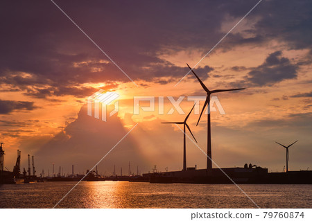 Wind turbines in Antwerp port on sunset. 79760874