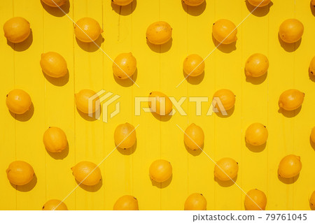 juicy lemons on bright yellow background juicy lemons on bright yellow background 79761045