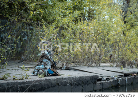 garbage, plastic bags and waste on industrial city river after spring flood garbage, plastic bags and waste on industrial city river after spring flood 79762759