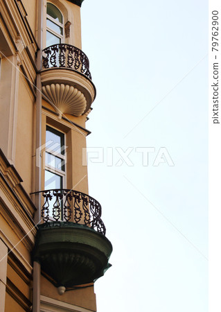 Old town architecture building corner with rounded balconies on light sky background Old town architecture building corner with rounded balconies on light sky background 79762900