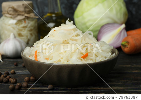 Fresh sauerkraut and ingredients on wooden table Fresh sauerkraut and ingredients on wooden table 79763387
