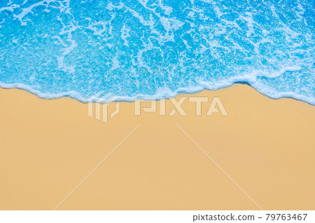 Blue seaside water on light yellow beach sand coastline seashore background 79763467