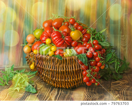 Tomatoes in wicker basket in the kitchen Tomatoes in wicker basket in the kitchen 79763703