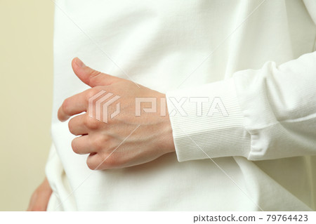 Young woman in white sweatshirt, close up 79764423