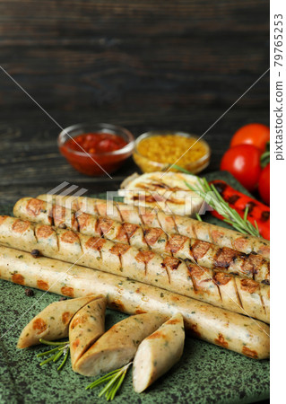 Concept of tasty food with grilled sausage on wooden table Concept of tasty food with grilled sausage on wooden table 79765253