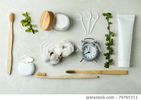 Oral care accessories on white textured background 79765311