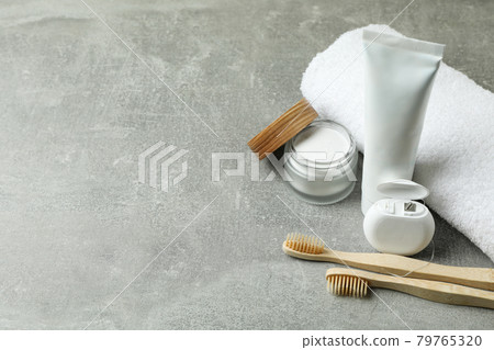 Oral care accessories on gray textured background 79765320