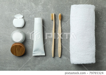 Oral care accessories on gray textured background 79765324
