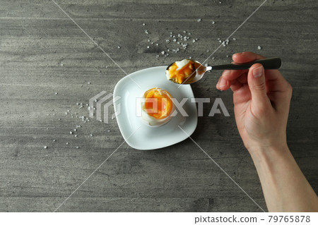 Concept of tasty breakfast with boiled egg on gray textured background 79765878