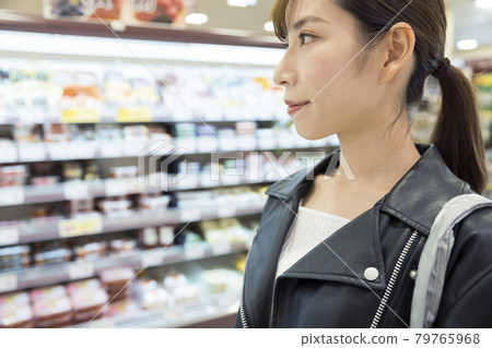 Shopping image of a young woman looking around the supermarket Shopping image of a young woman looking around the supermarket 79765968