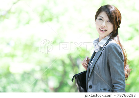 A smiling business woman looking back A smiling business woman looking back 79766288