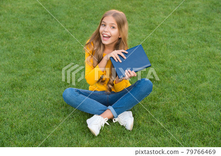 write childhood memories. kid read book in park. happy write childhood memories. kid read book in park. happy 79766469