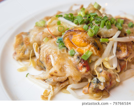 Crispy Fried Mussel Pancake served on White Plate. 79766584