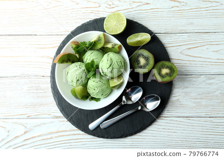 Tray with mint ice cream on white wooden background 79766774