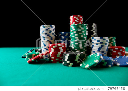 Stack of Casino gambling chips on green table Stack of Casino gambling chips on green table 79767458