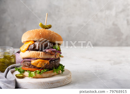 Home made burgers with two cutlets and jalapeno on a concrete gray background 79768915