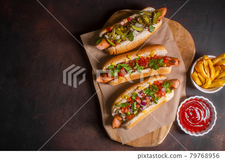 Hot dogs with different mexican toppings, top view, dark background 79768956
