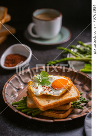 Fresh sandwiches with fried egg served on a vintage metallic plate Fresh sandwiches with fried egg served on a vintage metallic plate 79768984