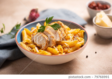 Pasta penne with cajun sauce and fried chicken 79768991