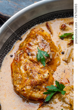 Tasty Cajun chicken in a creamy sauce prepared in a pan Tasty Cajun chicken in a creamy sauce prepared in a pan 79768993