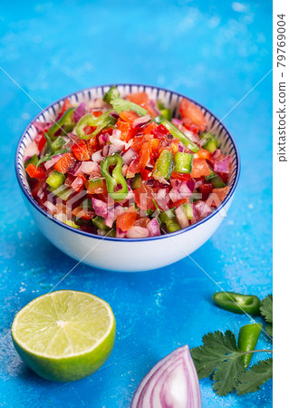 Homemade salsa pico de gallo, mexican cuisine, blue background 79769004