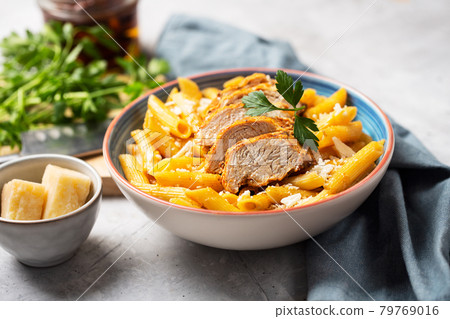 Pasta penne with cajun sauce and fried chicken 79769016