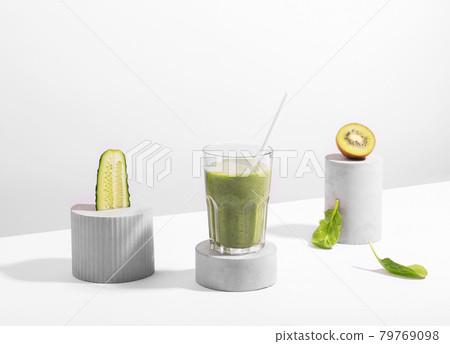 Conceptual creative still life with green fruits and smoothie over white background Conceptual creative still life with green fruits and smoothie over white background 79769098