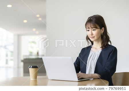 Business woman working on a laptop Casual business image 79769951
