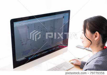 Female engineer working in front of a computer Female engineer working in front of a computer 79770356