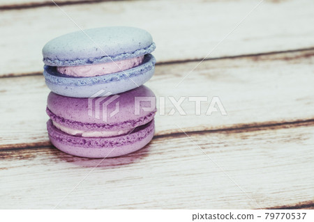 Multicolored macarons on a table and white wall background Multicolored macarons on a table and white wall background 79770537
