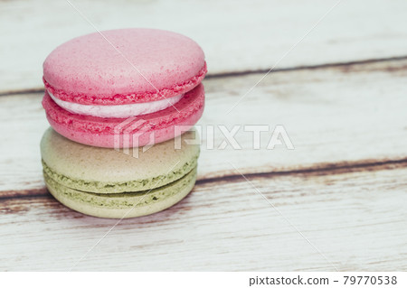 Multicolored macarons on a table and white wall background Multicolored macarons on a table and white wall background 79770538
