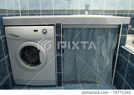Modern bathroom with blue tiles  and washing machine 79771160