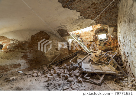Old forsaken empty basement room of ancient building or palace with cracked plastered brick walls, low ceiling, small windows with and rubbish on dirty floor. Old forsaken empty basement room of ancient building or palace with cracked plastered brick walls, low ceiling, small windows with and rubbish on dirty floor. 79771681