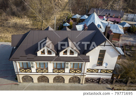 Aerial view of big house mansion complex on fenced property in ecological area on bright sunny day. Modern architecture, riches and luxury concept. 79771695