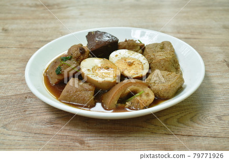 boiled half cut egg with tofu in herb brown soup and pork leg on plate boiled half cut egg with tofu in herb brown soup and pork leg on plate 79771926