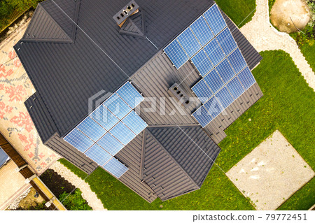 Aerial view of a rural private house with solar photovoltaic panels for producing clean electricity on roof. Autonomous home concept. 79772451