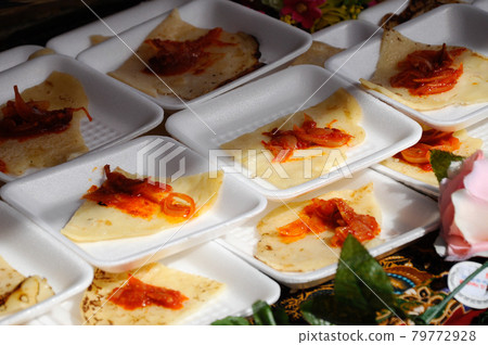 Traditional Malaysian pencake local called lempeng. Eat together with fried chili sauce called sambal.  79772928