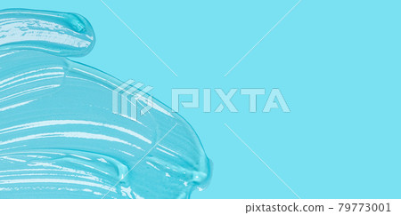 Transparent clear liquid gel cosmetic spot drops texture blue solid color background 79773001