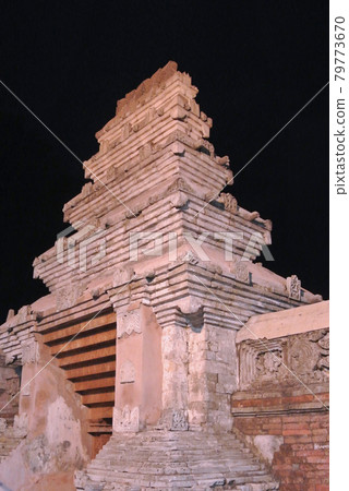 JOGJAKARTA, INDONESIA -JUNE 12, 2014: Entrance arch at old Masjid Besar Mataram Kotagede, Jogjakarta Indonesia. The arch was made from brick and hand made carving stone in traditional Balinese Style JOGJAKARTA, INDONESIA -JUNE 12, 2014: Entrance arch at old Masjid Besar Mataram Kotagede, Jogjakarta Indonesia. The arch was made from brick and hand made carving stone in traditional Balinese Style 79773670