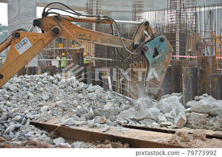 JOHOR, MALAYSIA -JUNE 26, 2016: Concrete hacking machine used to crush waste concrete to small pieces at the construction site in Malaysia. 79773992