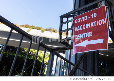 Direction signage to covid-19 vaccination centre at public infrastructure 79774270