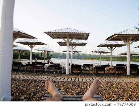 Relax on the beach. The guy is resting on the beach. Relax on the beach. The guy is resting on the beach. 79774309
