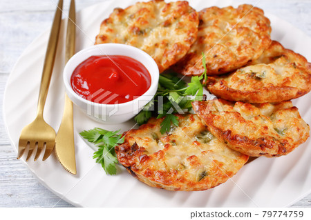 Cheesy Chicken Fritters on a plate, top view Cheesy Chicken Fritters on a plate, top view 79774759