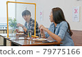Asian man and woman having lunch meal in local restaurant, sit in social distance with partition 79775166