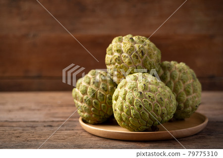 Close up sugar apple fruit (Custard Apple) on wooden plate on wood table 79775310